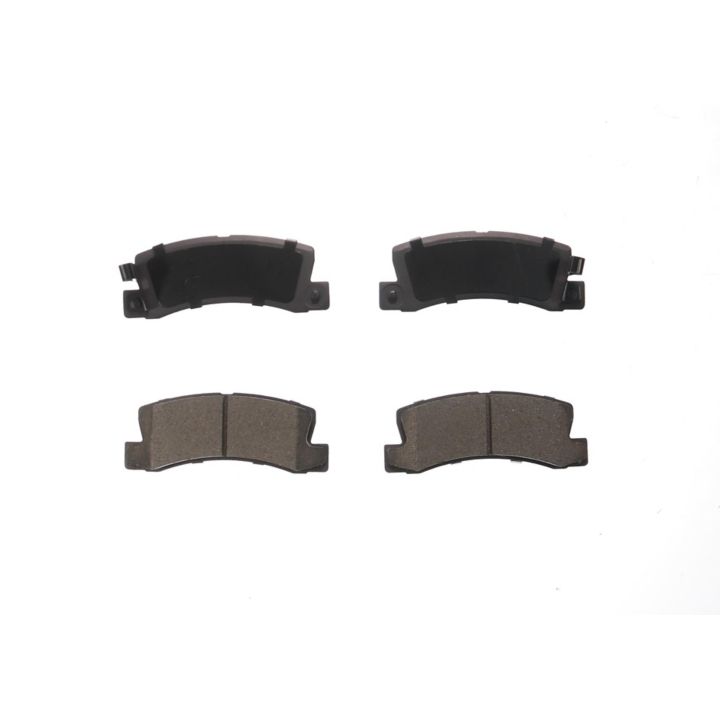 Four BFD325CR ProSeries OE Brake Pads, with two facing up revealing the pad material and two facing down showing the metal backing plate.