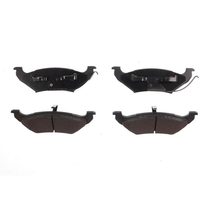 Four BFD715SM ProSeries OE Brake Pads in black, with two featuring metal clips on the top row and the other two having friction surfaces on the bottom row.