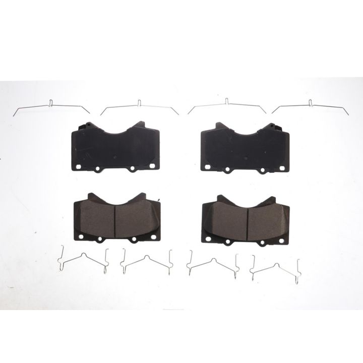 Four BFD1303CR ProSeries OE Brake Pads in black, arranged in two rows with metal clips laid out around them on a plain white background.