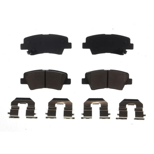 Four BFD1313CR ProSeries OE Brake Pads in black and four silver brake pad clips, symmetrically arranged on a white background.