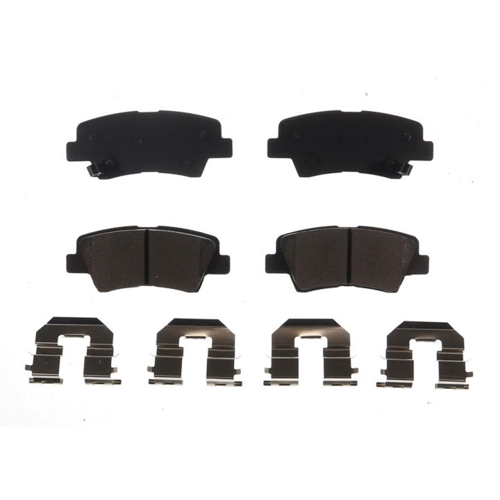 Four BFD1313CR ProSeries OE Brake Pads in black and four silver brake pad clips, symmetrically arranged on a white background.