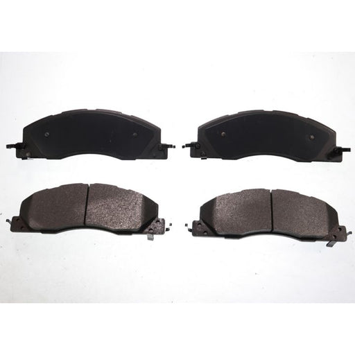 The BFD1399SM ProSeries OE Brake Pads are presented in a formation, with four black pads arranged against a white background; two are positioned side by side at the top and two at the bottom.