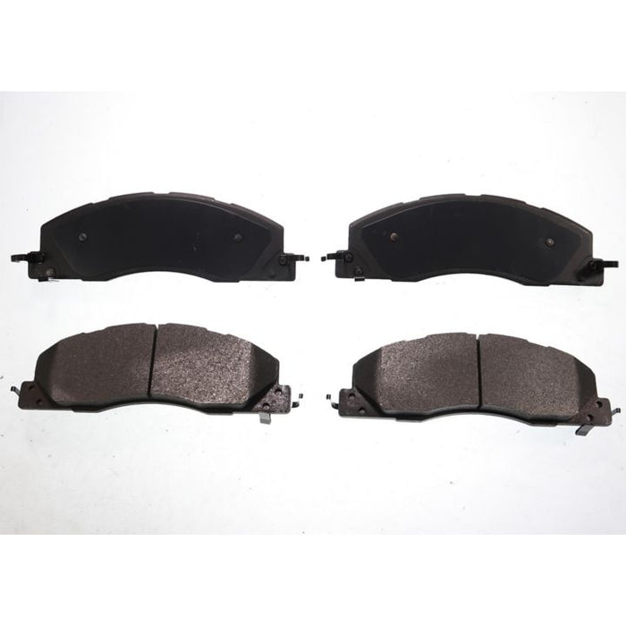 The BFD1399SM ProSeries OE Brake Pads are presented in a formation, with four black pads arranged against a white background; two are positioned side by side at the top and two at the bottom.