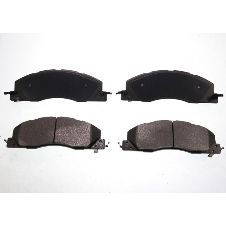 The BFD1399SM ProSeries OE Brake Pads are presented in a formation, with four black pads arranged against a white background; two are positioned side by side at the top and two at the bottom.