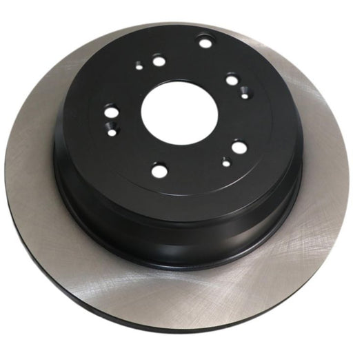 Close-up of the C06940 ProSeries OE+ Brake Rotor in black and silver, featuring multiple holes for screws or bolts.