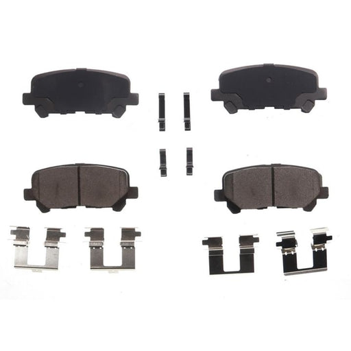 An image portraying four BFD1281CR ProSeries OE Brake Pads in black, along with various metal clips, all neatly displayed in a grid pattern against a white background.