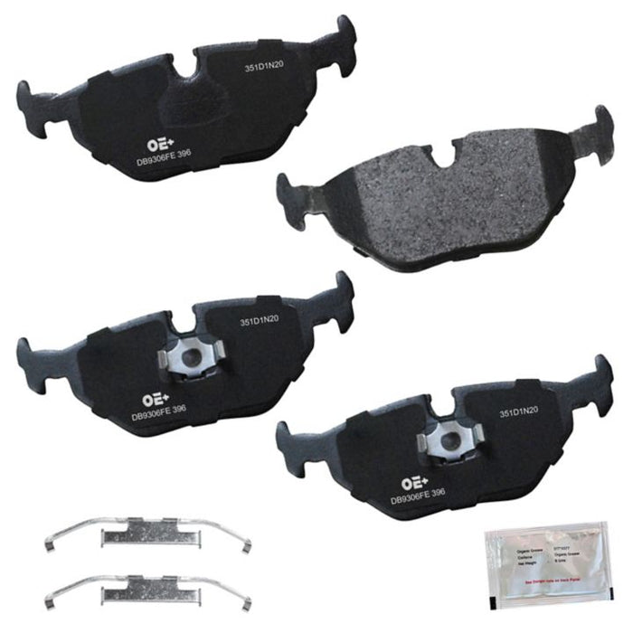 Four black **MMS396 ProSeries OE+** brake pads, two metal clips, and a small accessory packet are displayed against a white background.