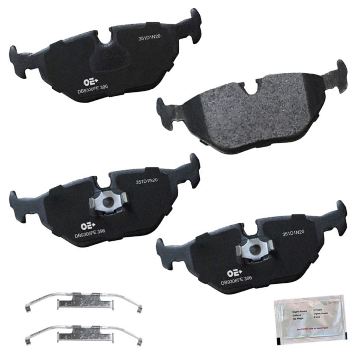 Four black **MMS396 ProSeries OE+** brake pads, two metal clips, and a small accessory packet are displayed against a white background.