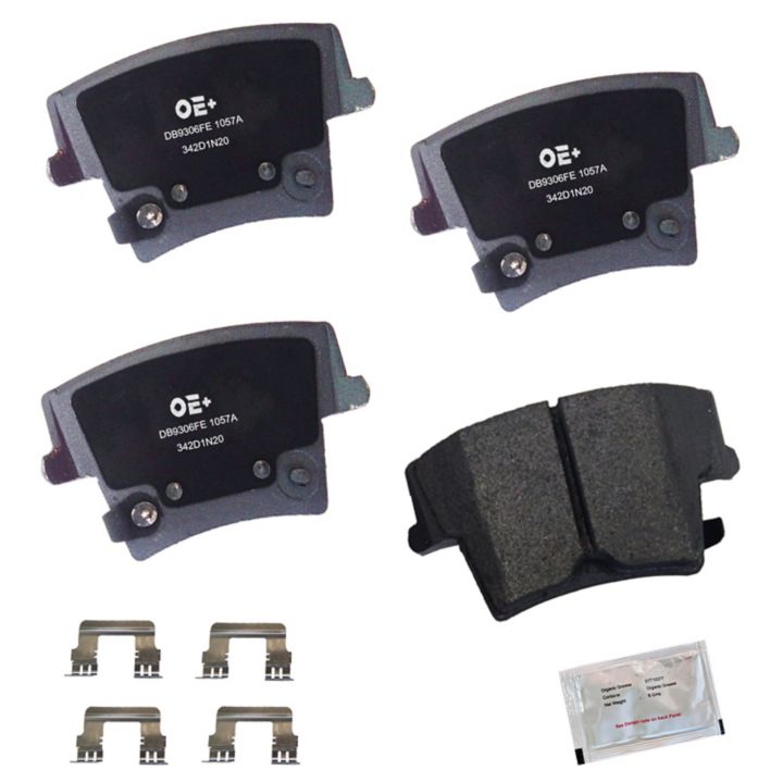 A set of four MMS1057A ProSeries OE+ Brake Pads, complete with metal clips and a packet of lubricant or grease.