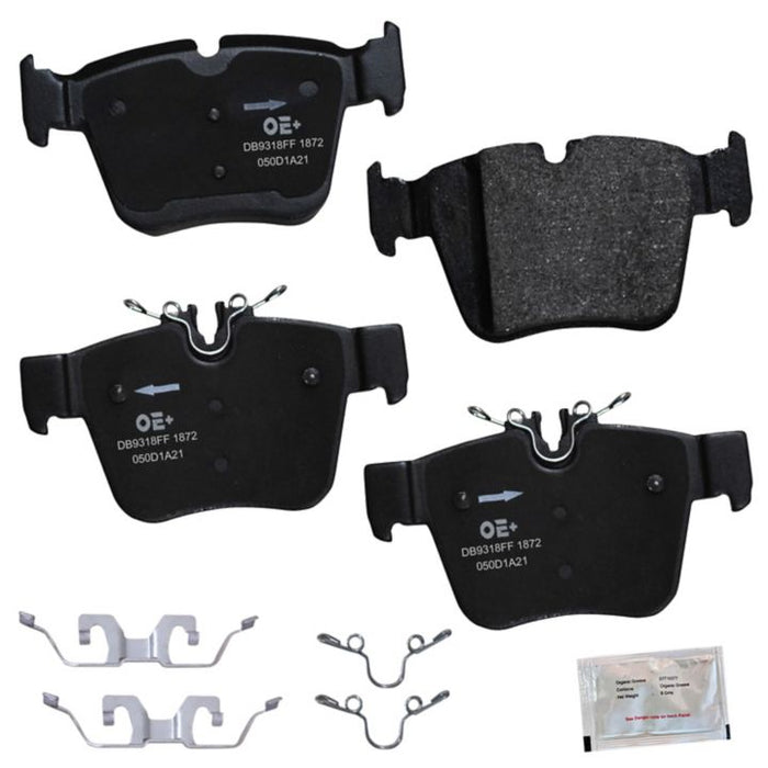 Four MMS1872 ProSeries OE+ Brake Pads, featuring metal clips and accompanied by a small packet of brake lubricant, arranged on a white background.