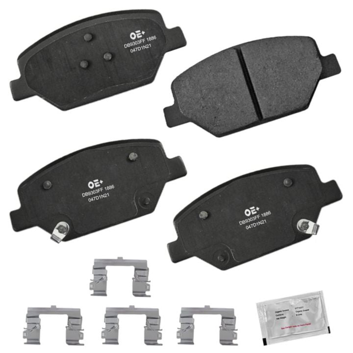 Four MMS1886 ProSeries OE+ black brake pads, along with the accompanying hardware including metal clips and a small packet, are laid out.