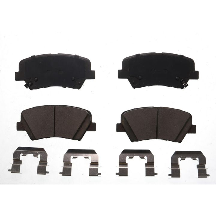 A set of four BFD1595CR ProSeries OE Brake Pads and four metal clips arranged on a white background.