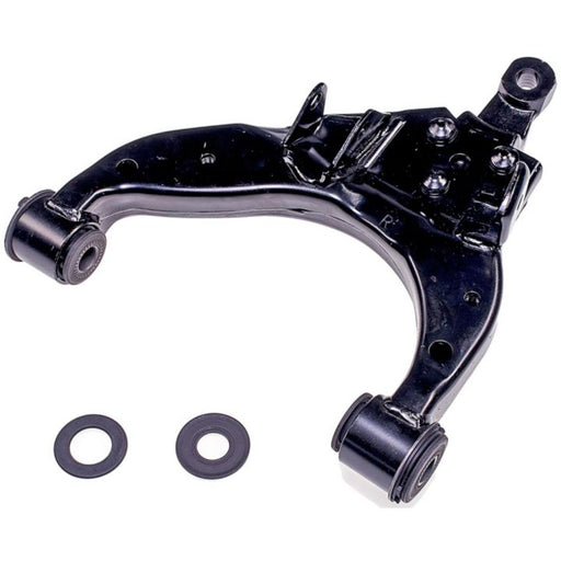 Close-up of a CA74324 ProSeries OE+ Control Arm in black with two bushings placed next to it on a white background.