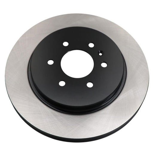 Close-up of the C09828 ProSeries OE+ Brake Rotor, a circular metal brake disc with a black center and silver outer edge, featuring five holes.