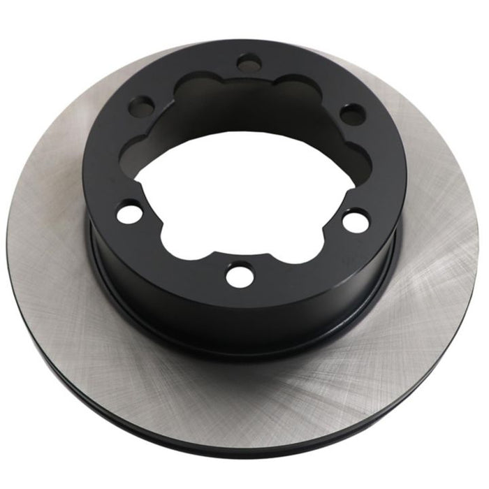 Close-up of a C09934 ProSeries OE+ Brake Rotor showcasing a silver outer surface and a black central hub with multiple holes.